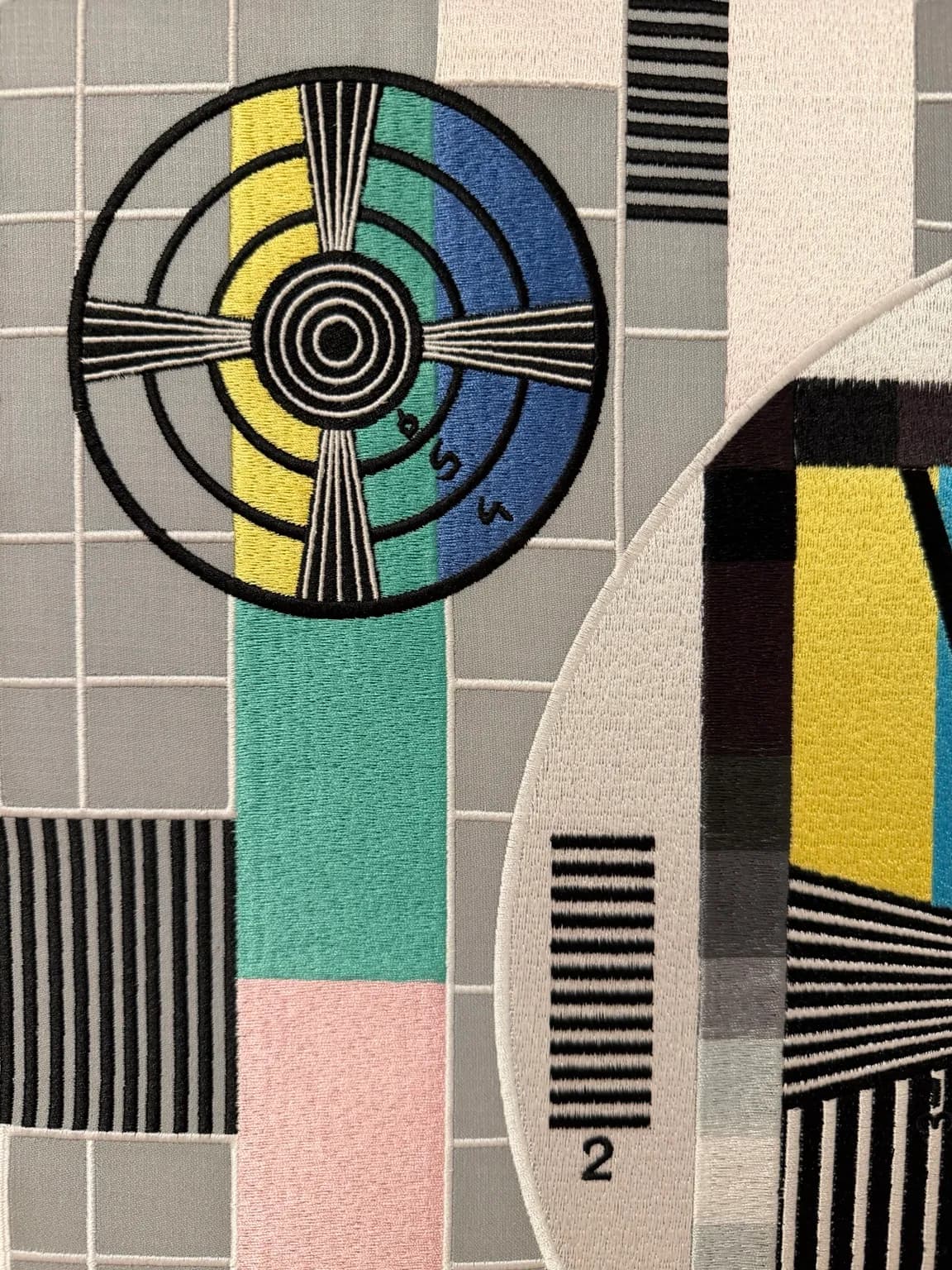Before the Broadcast (detail) — close-up of embroidered circular targets, calibration lines and contrasting colour fields